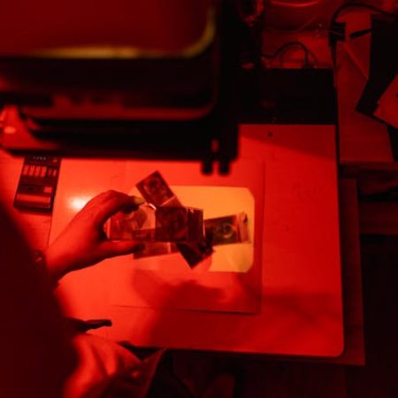 Technician adjusting printing machine settings during production